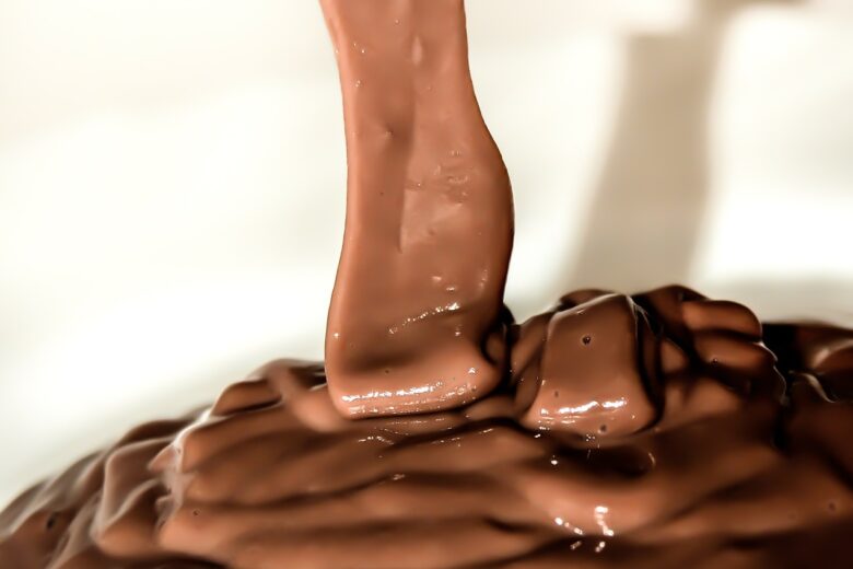 Chocolate pudding pouring into cup