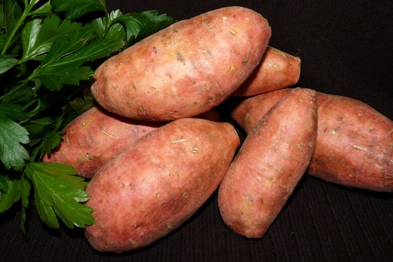 sweet potatoes lying with leaves