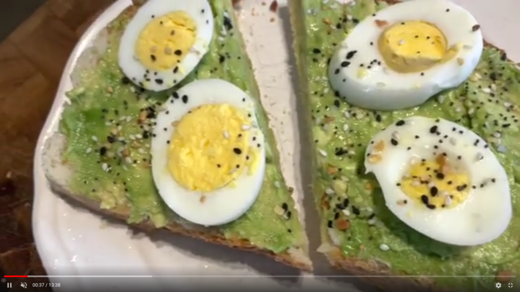 Avocado toast topped with hard boiled eggs.