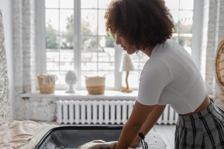 Girl packing essential oils for travel.